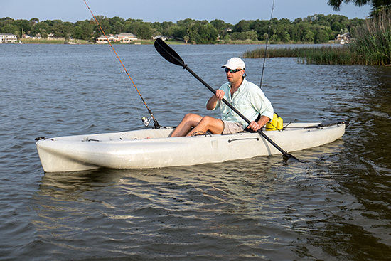 man fishing in kayak in florida lake